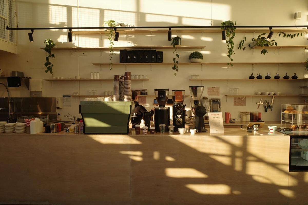 Golden hour light across the Refinery Coffee cafe counter, Currumbin