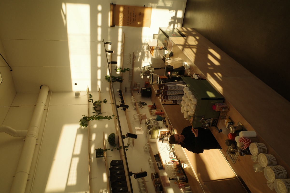 Mezzanine view over the Refinery Coffee cafe counter and barista
